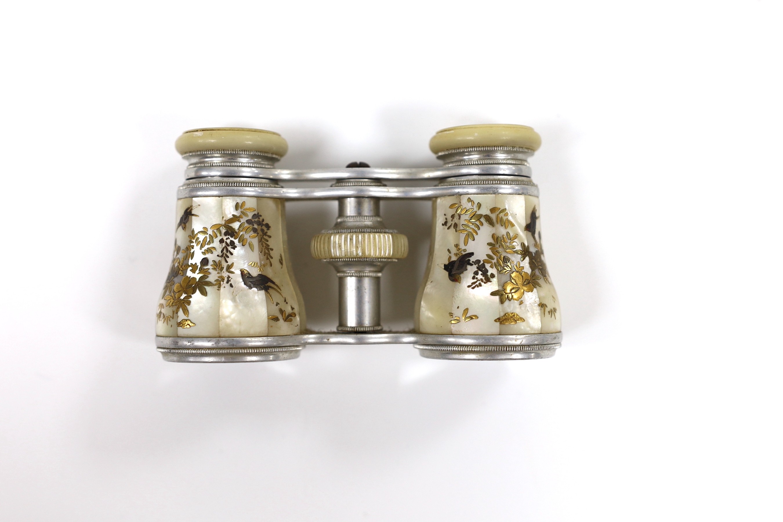 A pair of Victorian silvered metal opera glasses, with shibayama inlaid mother o'pearl lens barrels, 10cm wide
